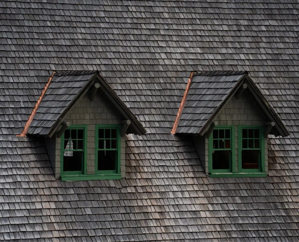 Dormers on a shingle roof in Springdale, AR, where step flashing and kickout flashing carry water past the walls